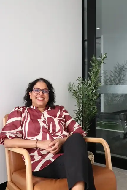 Lady with glasses smiling at the camera