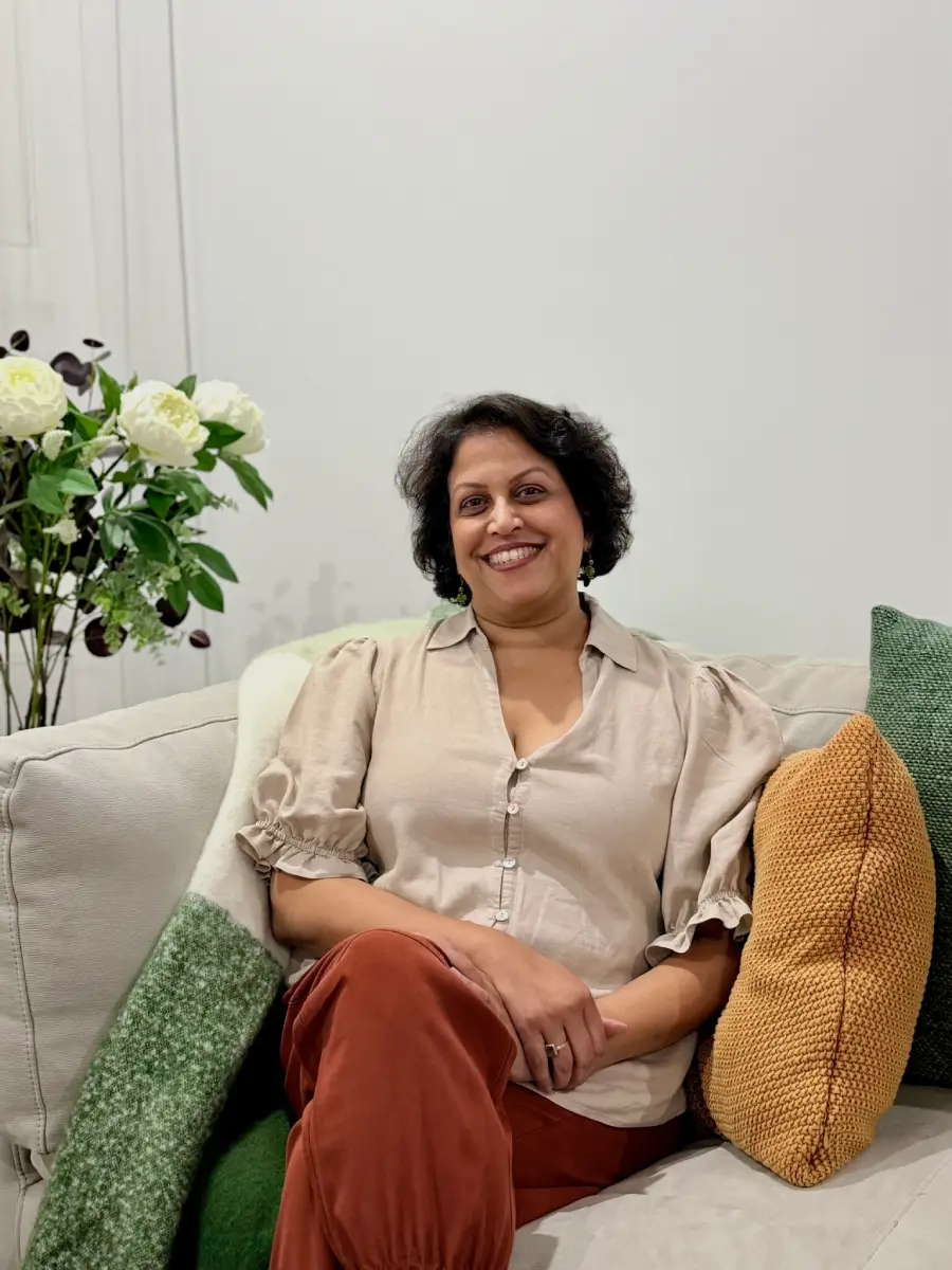 Lady sitting on the couch and smiling